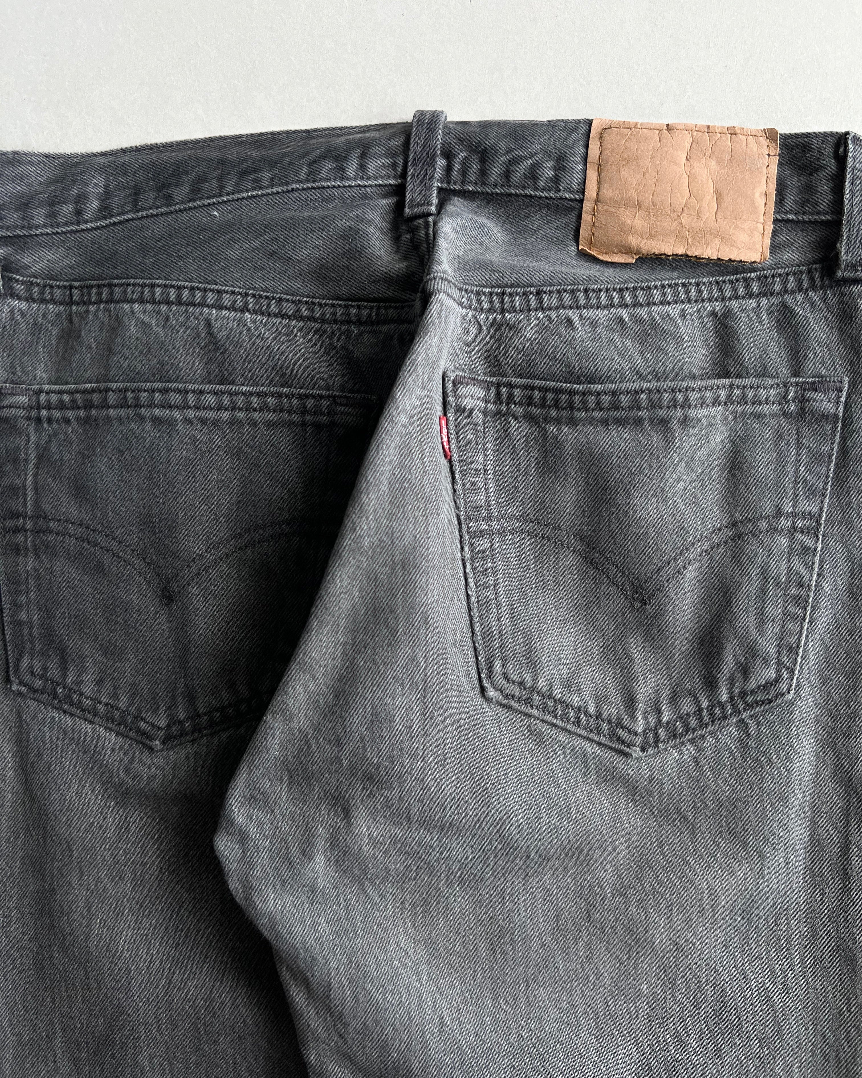 1990S FADED BLACK LEVI'S 501 RELEASED HEM JEANS (31X32)