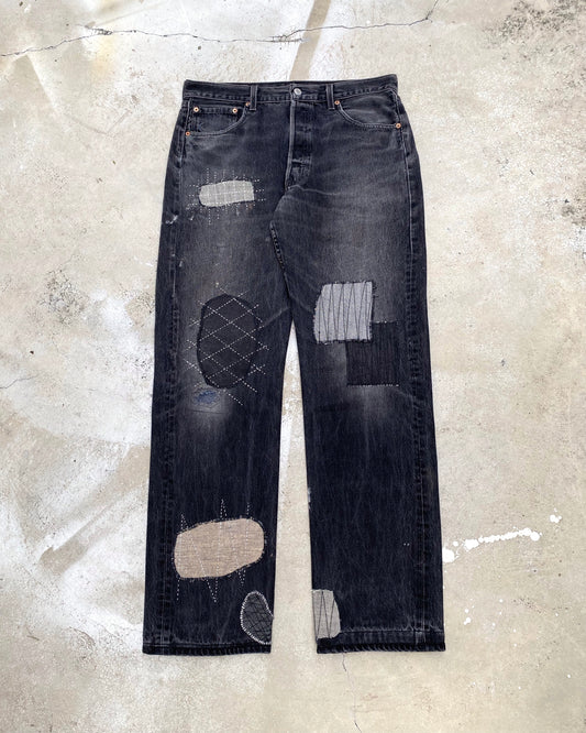 1990S FADED BLACK LEVI'S 501 PATCH JEANS (34X36)